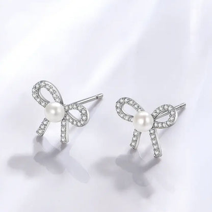 Cute bowknot stud earrings with pearl and crystal accents.