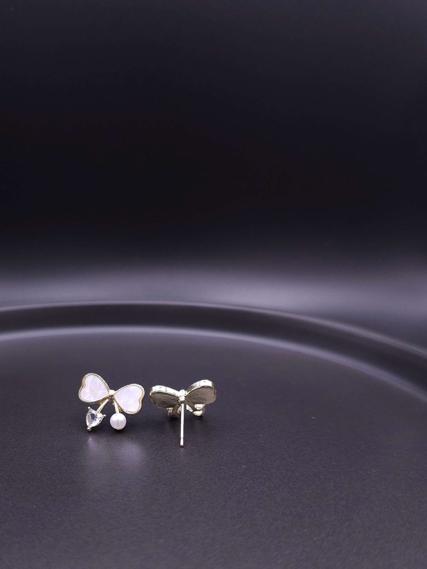 Back view of bow stud earrings showing the secure sterling silver post and fastening detail.