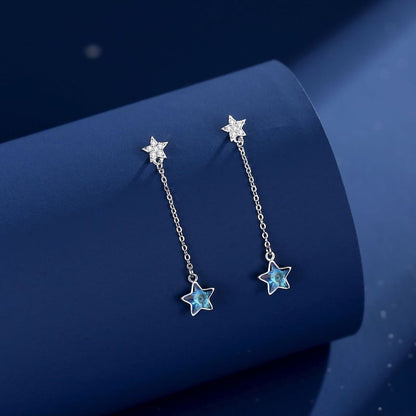 Crystal Star Dangle Earrings beautifully arranged on a display, reflecting light from the cubic zirconia stones.