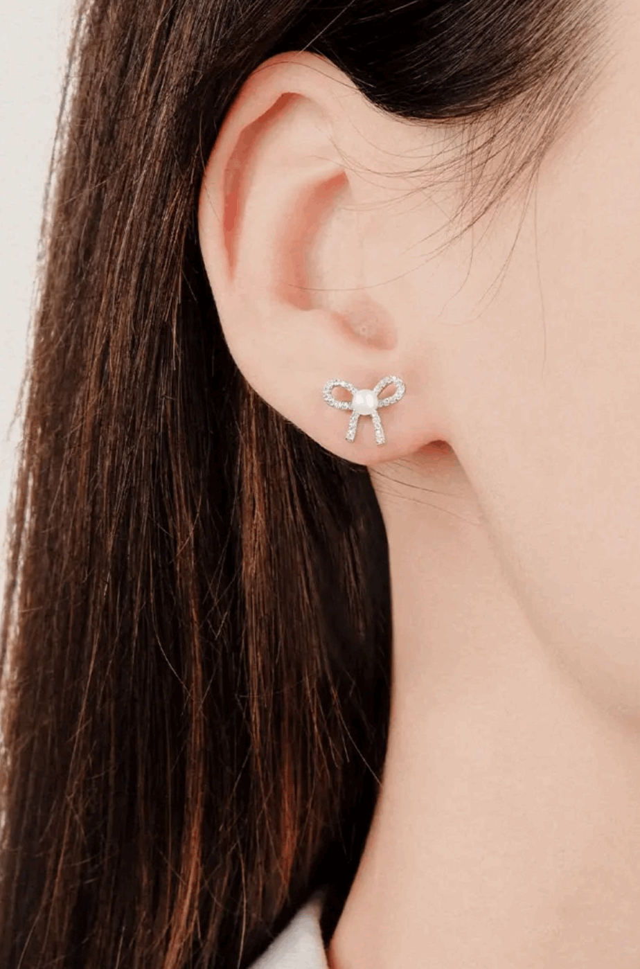 Cute bowknot stud earrings with pearl and crystal accents.