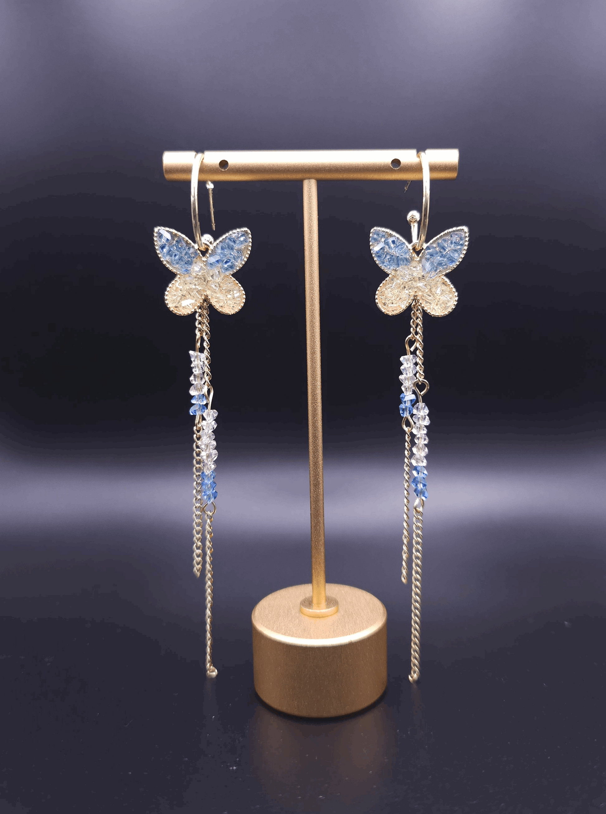 Front view of Fairy-tale Earrings featuring elegant butterfly dangle designs, highlighting the beautiful gold base and sparkling accents.