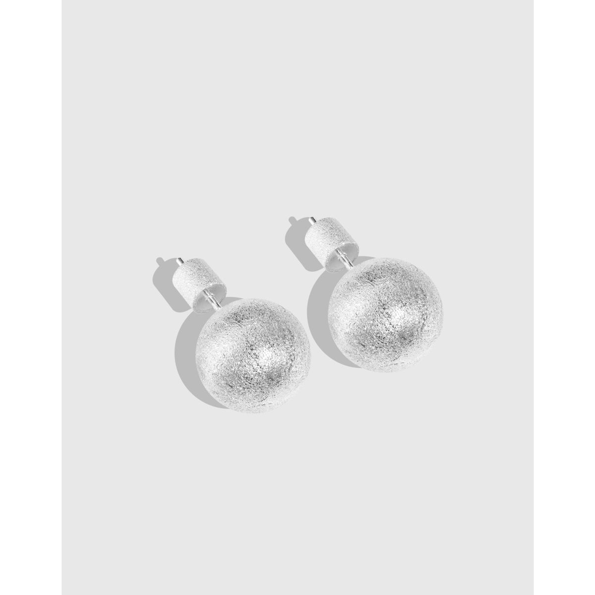 Luxurious brushed silver ball earrings with unique texture.