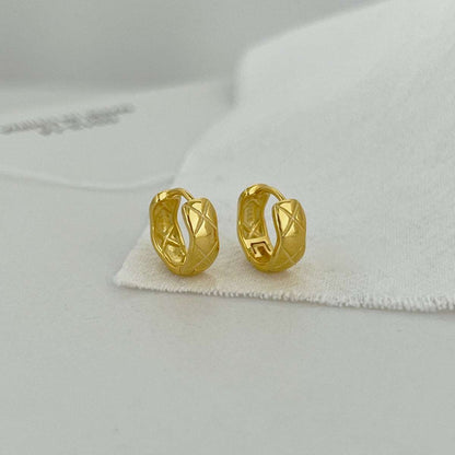 Front view of gold Embossing Huggie Earrings featuring an embossed texture and striking 18K gold plating.