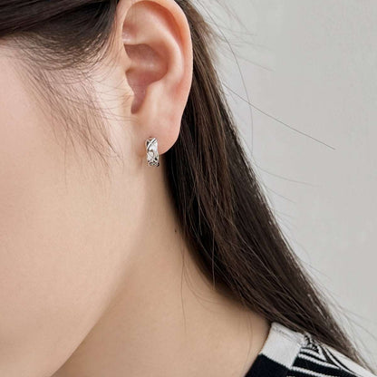 Model shot featuring silver Embossing Huggie Earrings, accentuating their stylish look in a casual outfit.