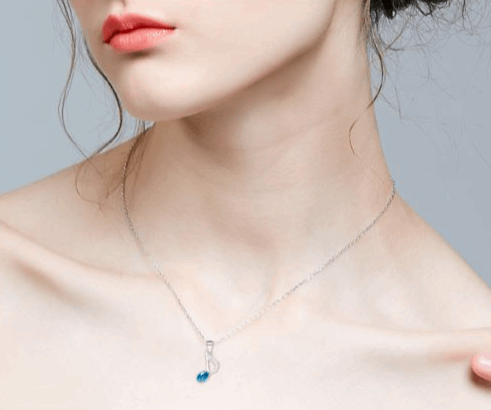 Stylish music note pendant necklace featuring an 8th-note-shaped pendant adorned with sparkling blue crystal, crafted from high-quality 925 silver and rhodium plated for lasting shine.