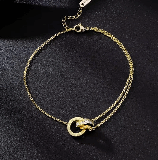 Interlock ring pendant anklet crafted from durable stainless steel and elegantly plated in 18k gold, available in both gold and rose gold finishes.