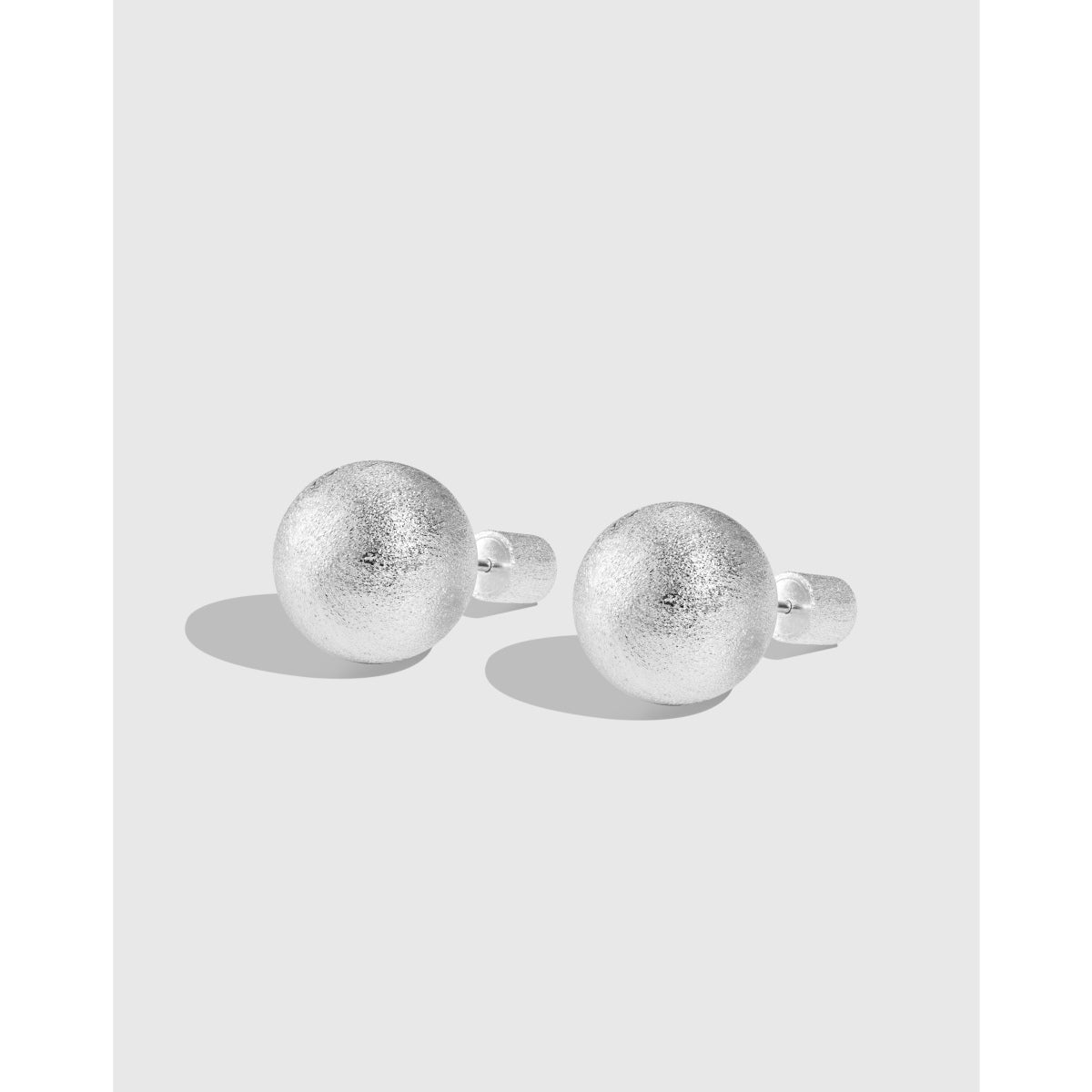 Luxurious brushed silver ball earrings with unique texture.