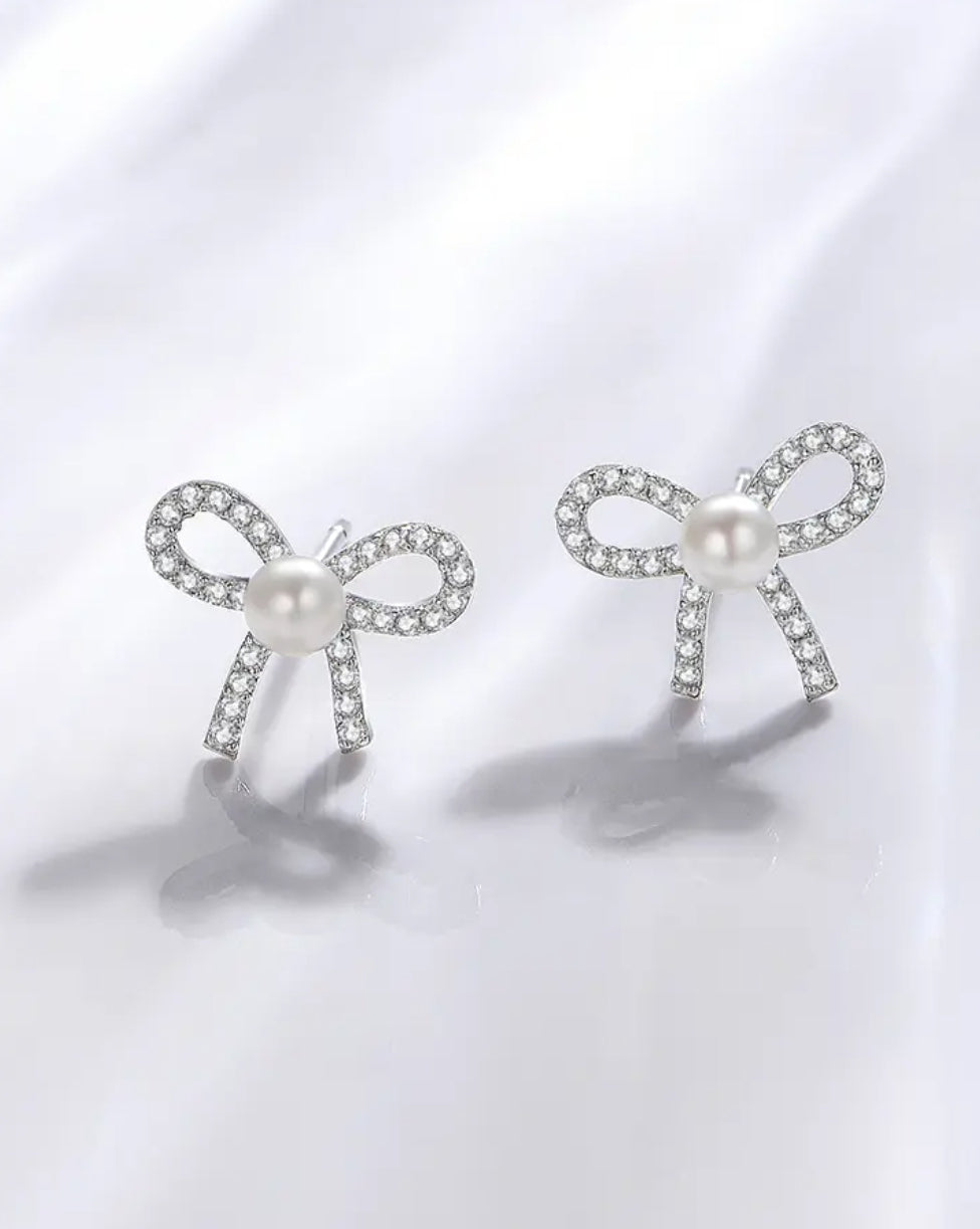 Cute bowknot stud earrings with pearl and crystal accents.