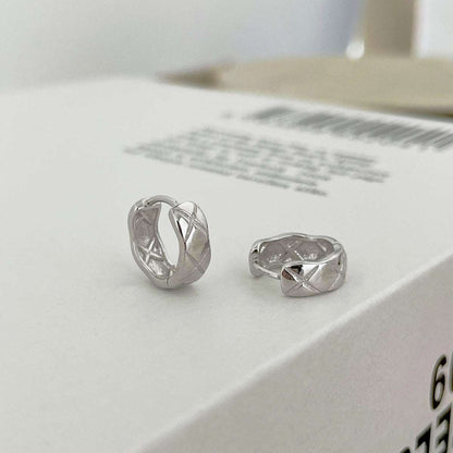 Side angle view of silver Embossing Huggie Earrings, highlighting the elegant design and luxurious rhodium finish.