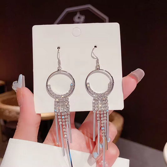 Elegant silver tassel earrings displayed in an image shot.  