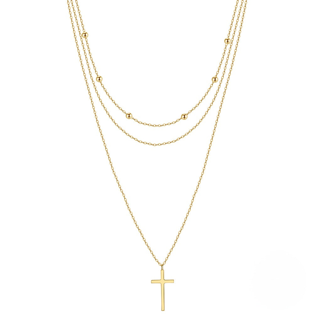 Triple layered silver necklace with cross pendant in two colors.