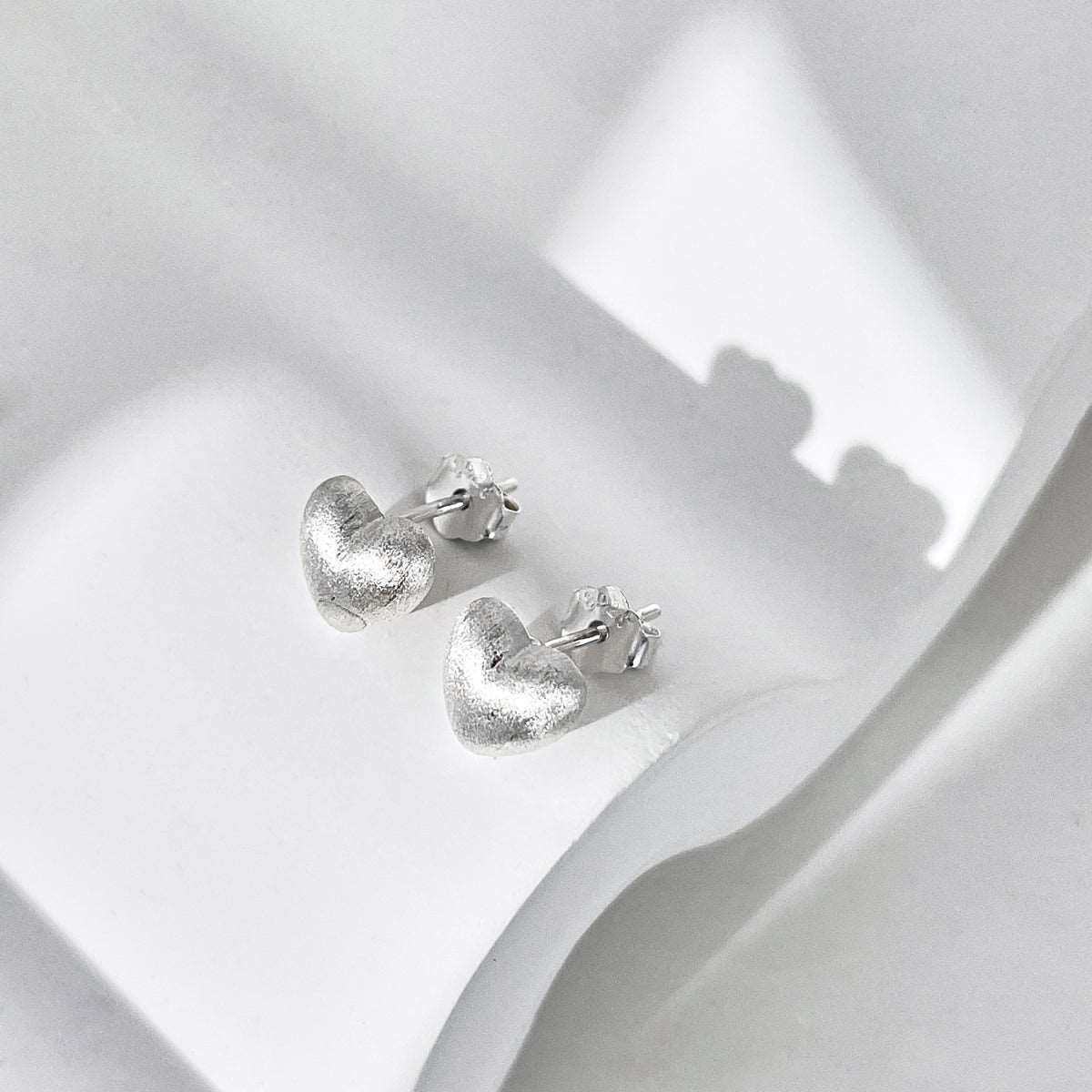 Small brushed silver heart earrings in 925 silver.