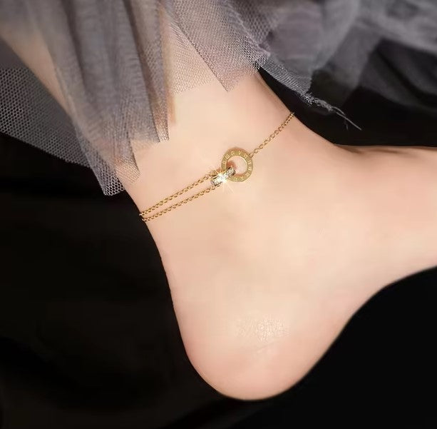 Interlock ring pendant anklet crafted from durable stainless steel and elegantly plated in 18k gold, available in both gold and rose gold finishes.